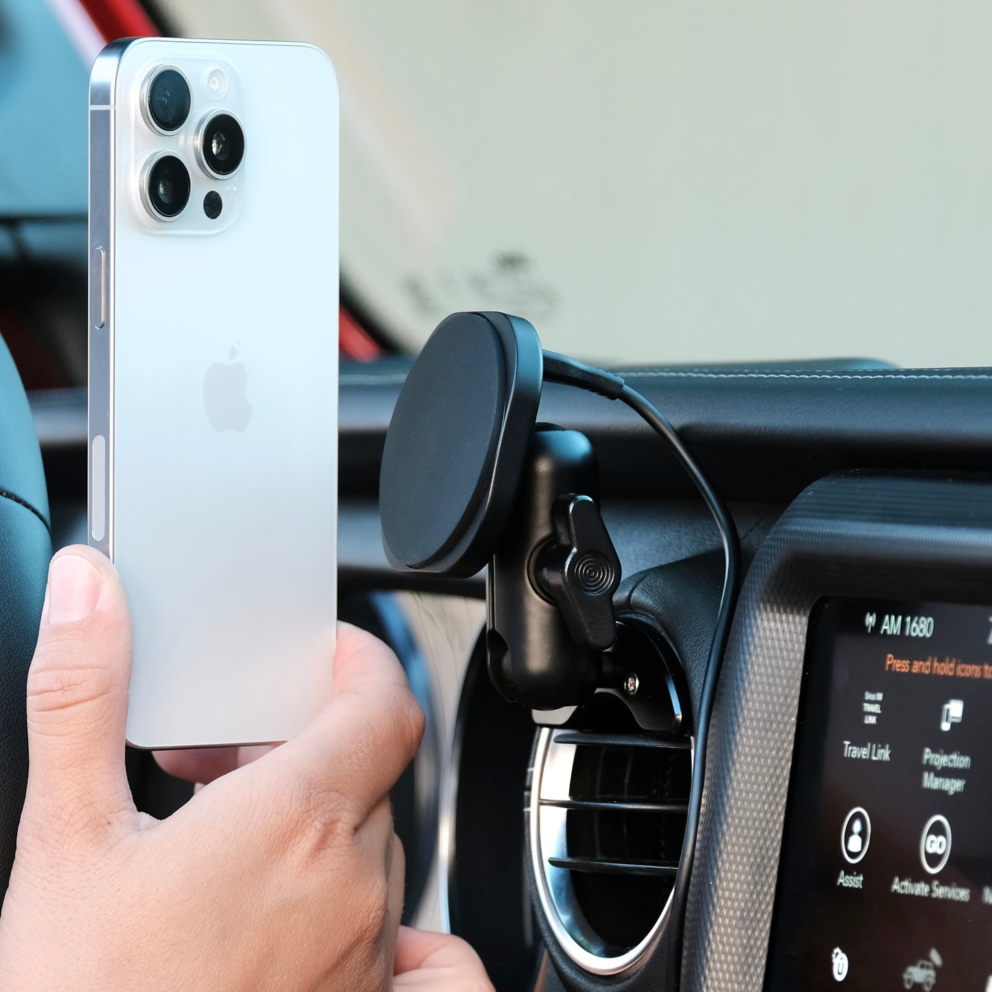 Image of Offroam MagSafe-compatible Phone Mount installed securely in Jeep Wrangler 2018-2023 | Gladiator 2019-2023. This premium phone mount installs easily without drilling or glue. High force magnets hold phone on any trail, road, or track. Perfect placement without blocking screens, driver view, or air flow. Fully adjustable positioning.
