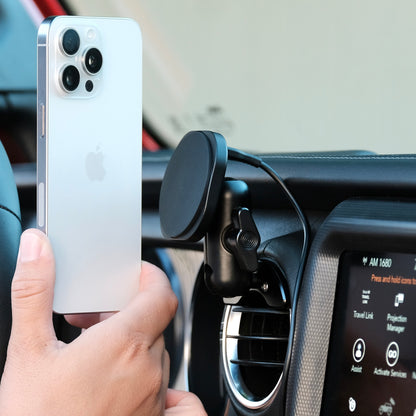 Image of Offroam MagSafe-compatible Phone Mount installed securely in Jeep Wrangler 2018-2023 | Gladiator 2019-2023. This premium phone mount installs easily without drilling or glue. High force magnets hold phone on any trail, road, or track. Perfect placement without blocking screens, driver view, or air flow. Fully adjustable positioning.
