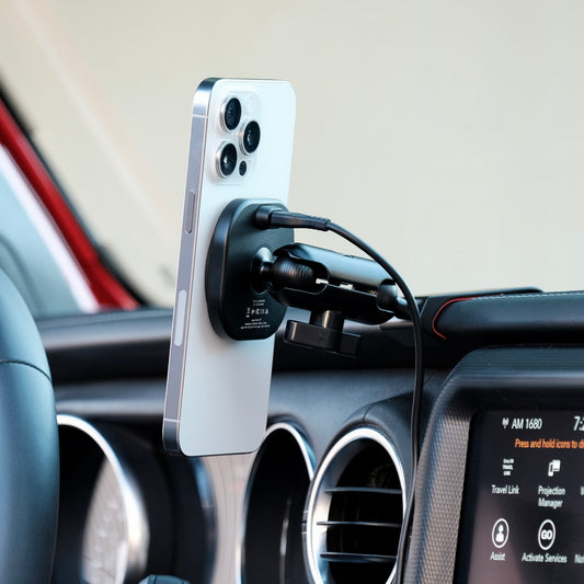 Image of Offroam MagSafe-compatible Phone Mount installed securely in Jeep Wrangler 2018-2023 | Gladiator 2019-2023. This premium phone mount installs easily without drilling or glue. High force magnets hold phone on any trail, road, or track. Perfect placement without blocking screens, driver view, or air flow. Fully adjustable positioning.