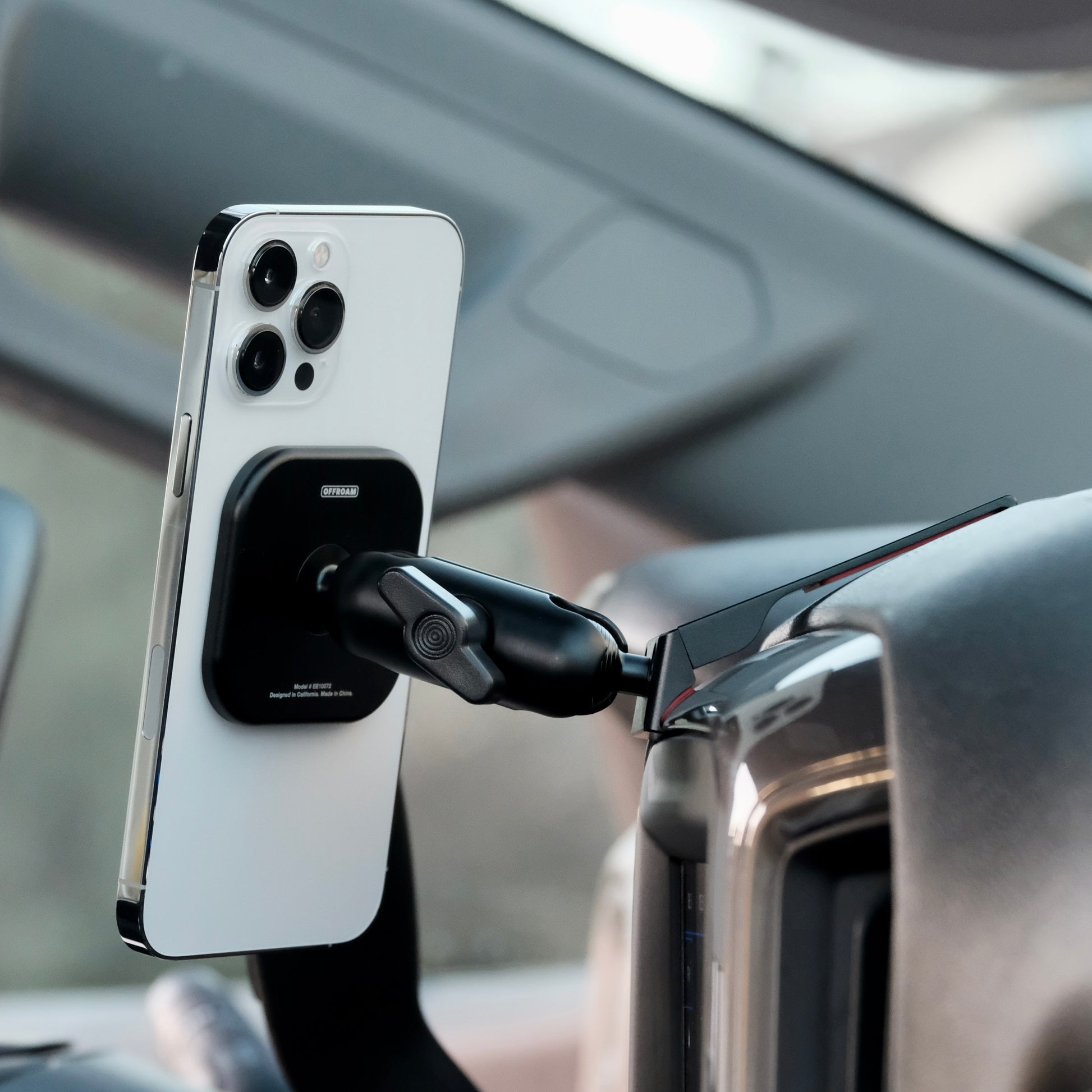 Image of Offroam MagSafe-compatible Phone Mount installed securely in Chevrolet Silverado 2019-2026 | Silverado HD 2020-2026 & GMC Sierra 1500 2019-2026 | Sierra HD 2020-2026 with 7-in.|8-in. display. This premium phone mount installs easily without drilling or glue. High force magnets hold phone on any trail, road, or track. Perfect placement without blocking screens, driver view, or air flow. Fully adjustable positioning.