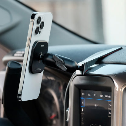 Image of Offroam MagSafe-compatible Phone Mount installed securely in Chevrolet Silverado 2019-2026 | Silverado HD 2020-2026 & GMC Sierra 1500 2019-2026 | Sierra HD 2020-2026 with 7-in.|8-in. display. This premium phone mount installs easily without drilling or glue. High force magnets hold phone on any trail, road, or track. Perfect placement without blocking screens, driver view, or air flow. Fully adjustable positioning.