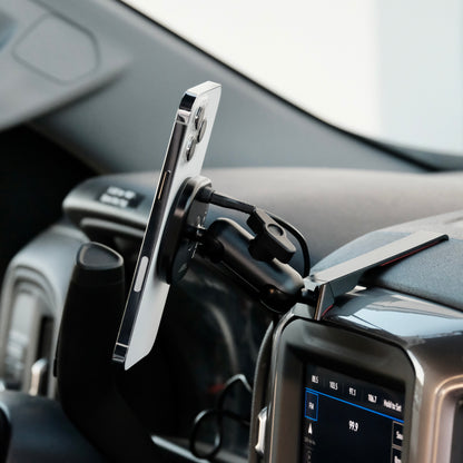 Image of Offroam MagSafe-compatible Phone Mount installed securely in Chevrolet Silverado 2019-2026 | Silverado HD 2020-2026 & GMC Sierra 1500 2019-2026 | Sierra HD 2020-2026 with 7-in.|8-in. display. This premium phone mount installs easily without drilling or glue. High force magnets hold phone on any trail, road, or track. Perfect placement without blocking screens, driver view, or air flow. Fully adjustable positioning.
