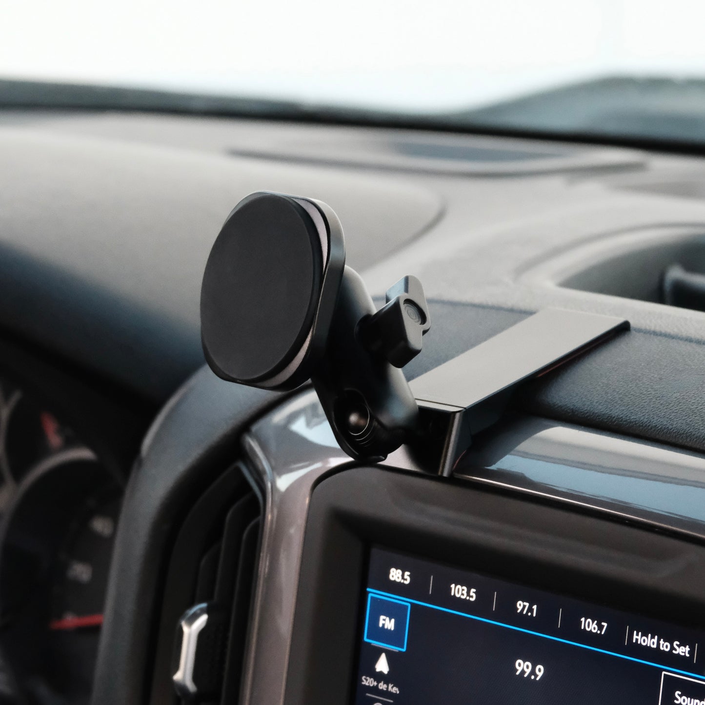 Image of Offroam MagSafe-compatible Phone Mount installed securely in Chevrolet Silverado 2019-2026 | Silverado HD 2020-2026 & GMC Sierra 1500 2019-2026 | Sierra HD 2020-2026 with 7-in.|8-in. display. This premium phone mount installs easily without drilling or glue. High force magnets hold phone on any trail, road, or track. Perfect placement without blocking screens, driver view, or air flow. Fully adjustable positioning.