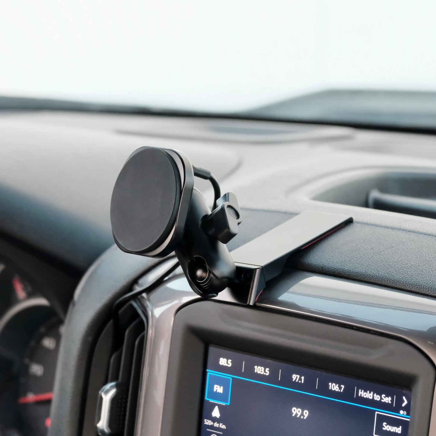 Image of Offroam MagSafe-compatible Phone Mount installed securely in Chevrolet Silverado 2019-2026 | Silverado HD 2020-2026 & GMC Sierra 1500 2019-2026 | Sierra HD 2020-2026 with 7-in.|8-in. display. This premium phone mount installs easily without drilling or glue. High force magnets hold phone on any trail, road, or track. Perfect placement without blocking screens, driver view, or air flow. Fully adjustable positioning.