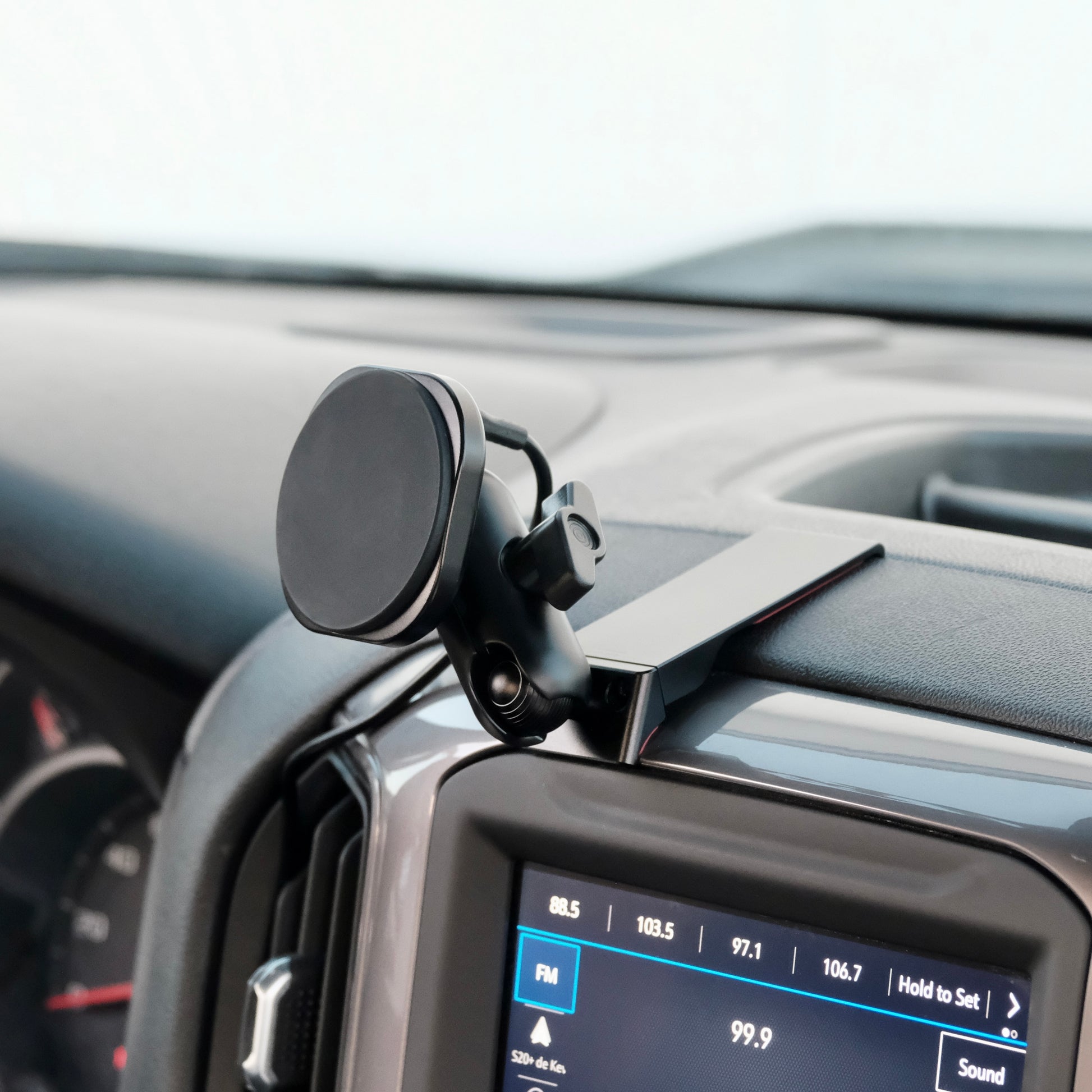 Image of Offroam MagSafe-compatible Phone Mount installed securely in Chevrolet Silverado 2019-2026 | Silverado HD 2020-2026 & GMC Sierra 1500 2019-2026 | Sierra HD 2020-2026 with 7-in.|8-in. display. This premium phone mount installs easily without drilling or glue. High force magnets hold phone on any trail, road, or track. Perfect placement without blocking screens, driver view, or air flow. Fully adjustable positioning.