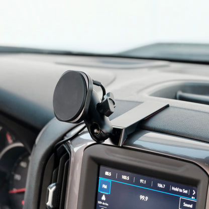 Image of Offroam MagSafe-compatible Phone Mount installed securely in Chevrolet Silverado 2019-2026 | Silverado HD 2020-2026 & GMC Sierra 1500 2019-2026 | Sierra HD 2020-2026 with 7-in.|8-in. display. This premium phone mount installs easily without drilling or glue. High force magnets hold phone on any trail, road, or track. Perfect placement without blocking screens, driver view, or air flow. Fully adjustable positioning.