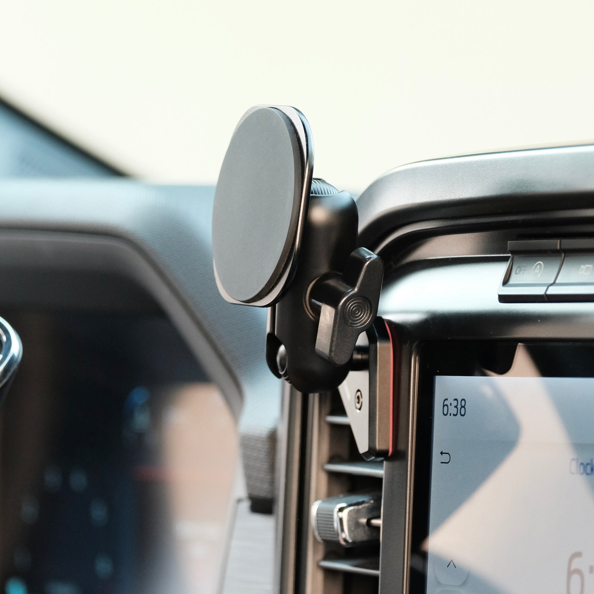 Image of Offroam MagSafe-compatible Phone Mount installed securely in Ford F-150 2021-2025 | F-250/F-350 2023-2025 | F-150 Lightning (XL & PRO) 2022-2025. This premium phone mount installs easily without drilling or glue. High force magnets hold phone on any trail, road, or track. Perfect placement without blocking screens, driver view, or air flow. Fully adjustable positioning.