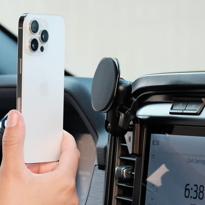 Image of Offroam MagSafe-compatible Phone Mount installed securely in Ford F-150 2021-2025 | F-250/F-350 2023-2025 | F-150 Lightning (XL & PRO) 2022-2025. This premium phone mount installs easily without drilling or glue. High force magnets hold phone on any trail, road, or track. Perfect placement without blocking screens, driver view, or air flow. Fully adjustable positioning.
