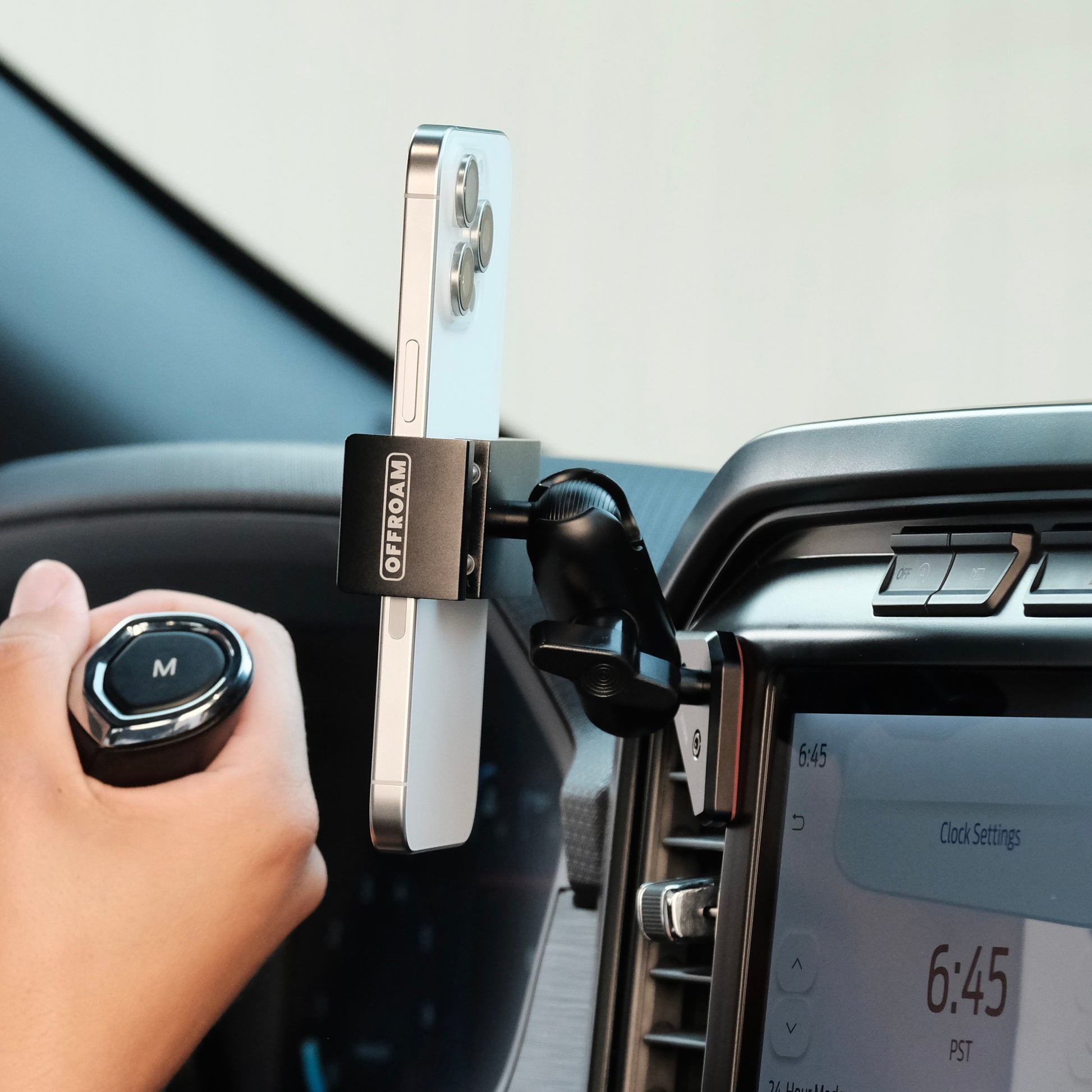 Image of Offroam Phone Mount installed securely in Ford F-150 2021-2025 | F-250/F-350 2023-2025 | F-150 Lightning (XL & PRO) 2022-2025. This premium phone mount installs easily without drilling or glue. Spring loaded Universal holder for use with any phone. Perfect placement without blocking screens, driver view, or air flow. Fully adjustable positioning.