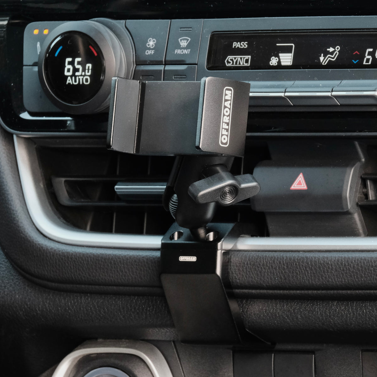 Image of Offroam Phone Mount installed securely in Toyota Grand Highlander 2024-2026. This premium phone mount installs easily without drilling or glue. Spring loaded Universal holder for use with any phone. Perfect placement without blocking screens, driver view, or air flow. Fully adjustable positioning.