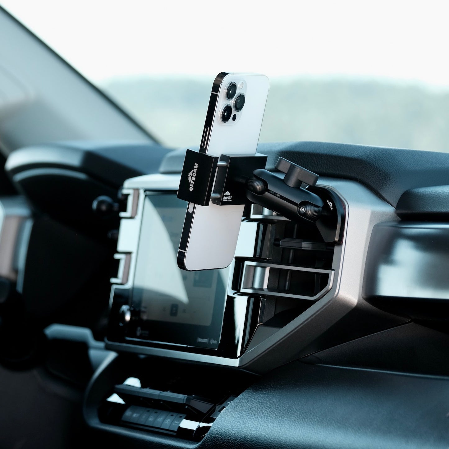 Image of Offroam Phone Mount installed securely in Toyota Tundra 2022-2026 | Sequoia 2023-2026. This premium phone mount installs easily without drilling or glue. Spring loaded Universal holder for use with any phone. Perfect placement without blocking screens, driver view, or air flow. Fully adjustable positioning.