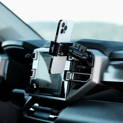 Image of Offroam Phone Mount installed securely in Toyota Tundra 2022-2026 | Sequoia 2023-2026. This premium phone mount installs easily without drilling or glue. Spring loaded Universal holder for use with any phone. Perfect placement without blocking screens, driver view, or air flow. Fully adjustable positioning.