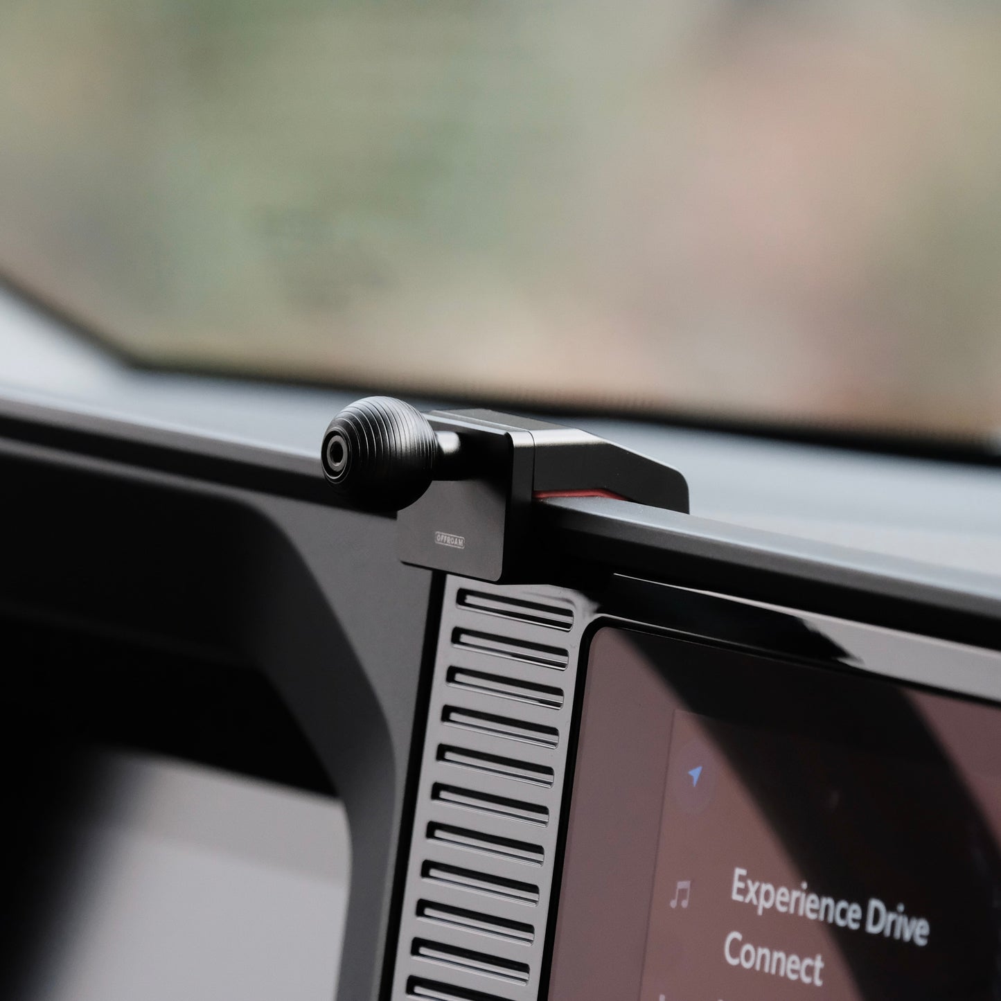 Image of Offroam Mounting Base installed securely in Toyota Land Cruiser 250 2024-2025. This premium all metal phone mounting base installs easily without drilling or glue. Perfect placement without blocking screens, driver view, or air flow.